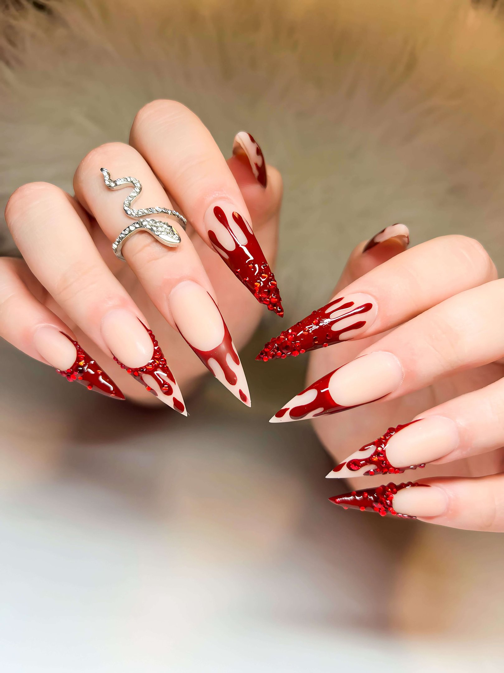Stiletto fall nails with red blood-drip design and red crystal accents.