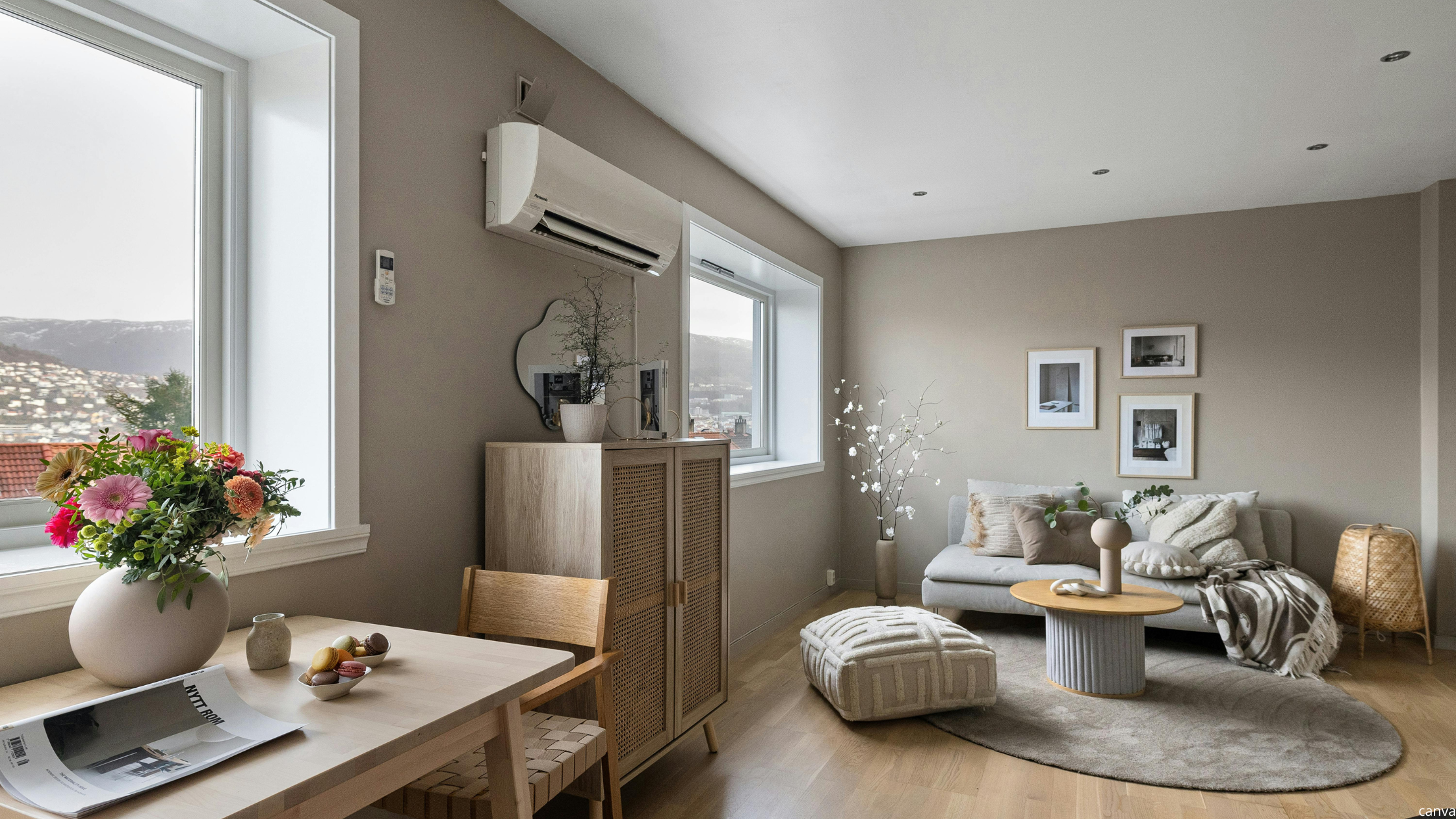 Cosy home decor in a small modern living room with neutral tones, soft grey sofa, wooden furniture, and minimalist wall art.