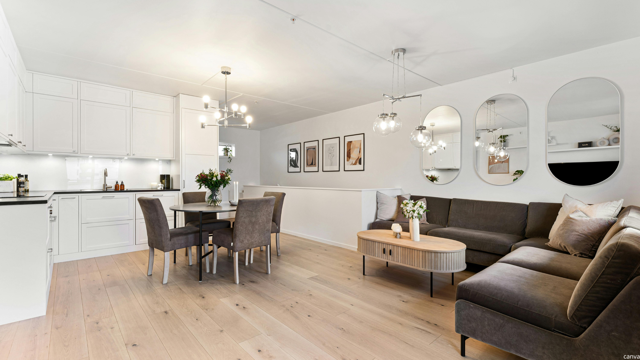 Cosy home decor with a modern open-plan living room and kitchen, featuring a brown sectional sofa, wooden dining table, wall mirrors, and warm lighting.