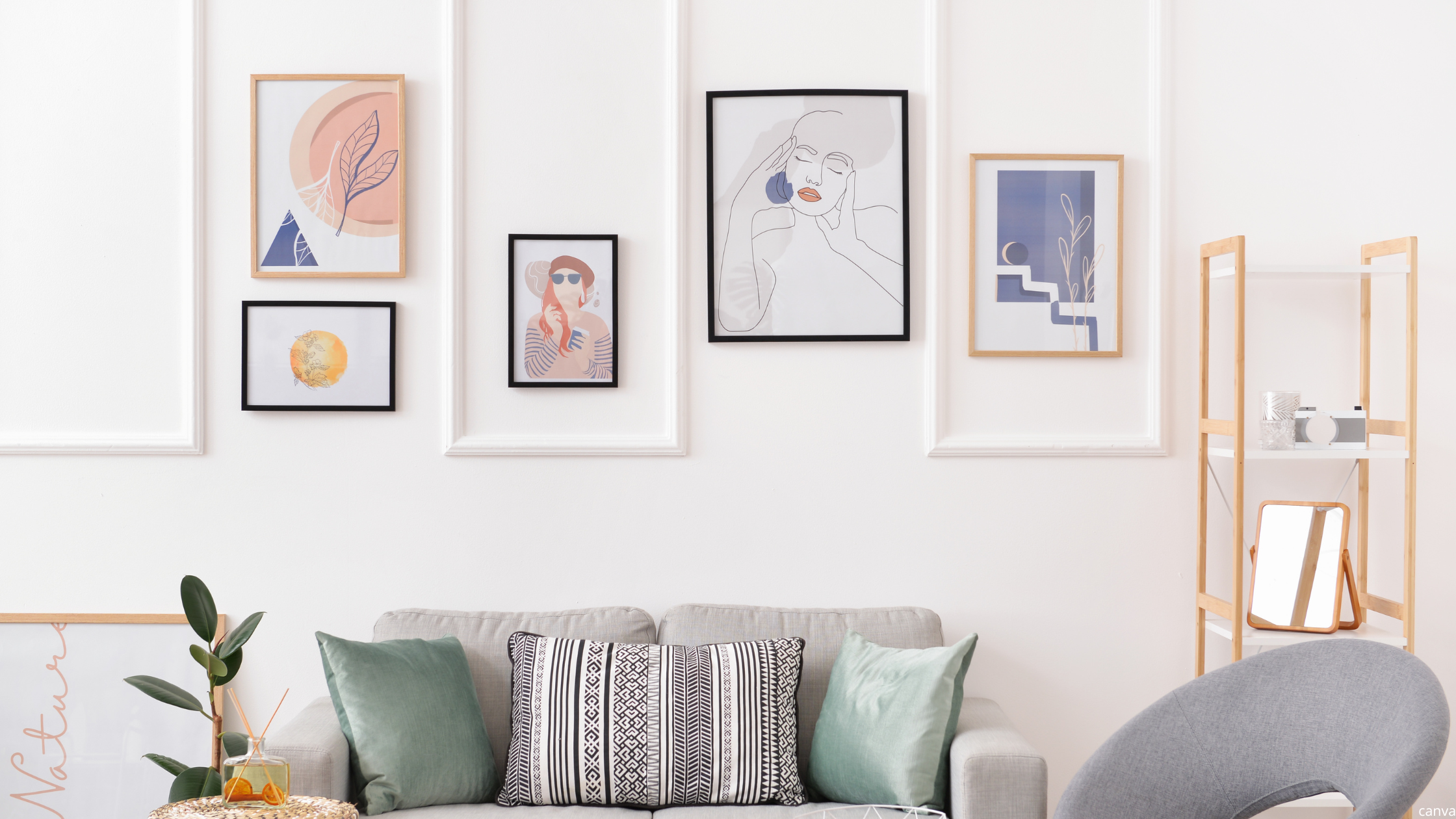 Modern cosy home decor with a neutral sofa, patterned cushions, wall art gallery, and minimalist shelving for a light and inviting living room.