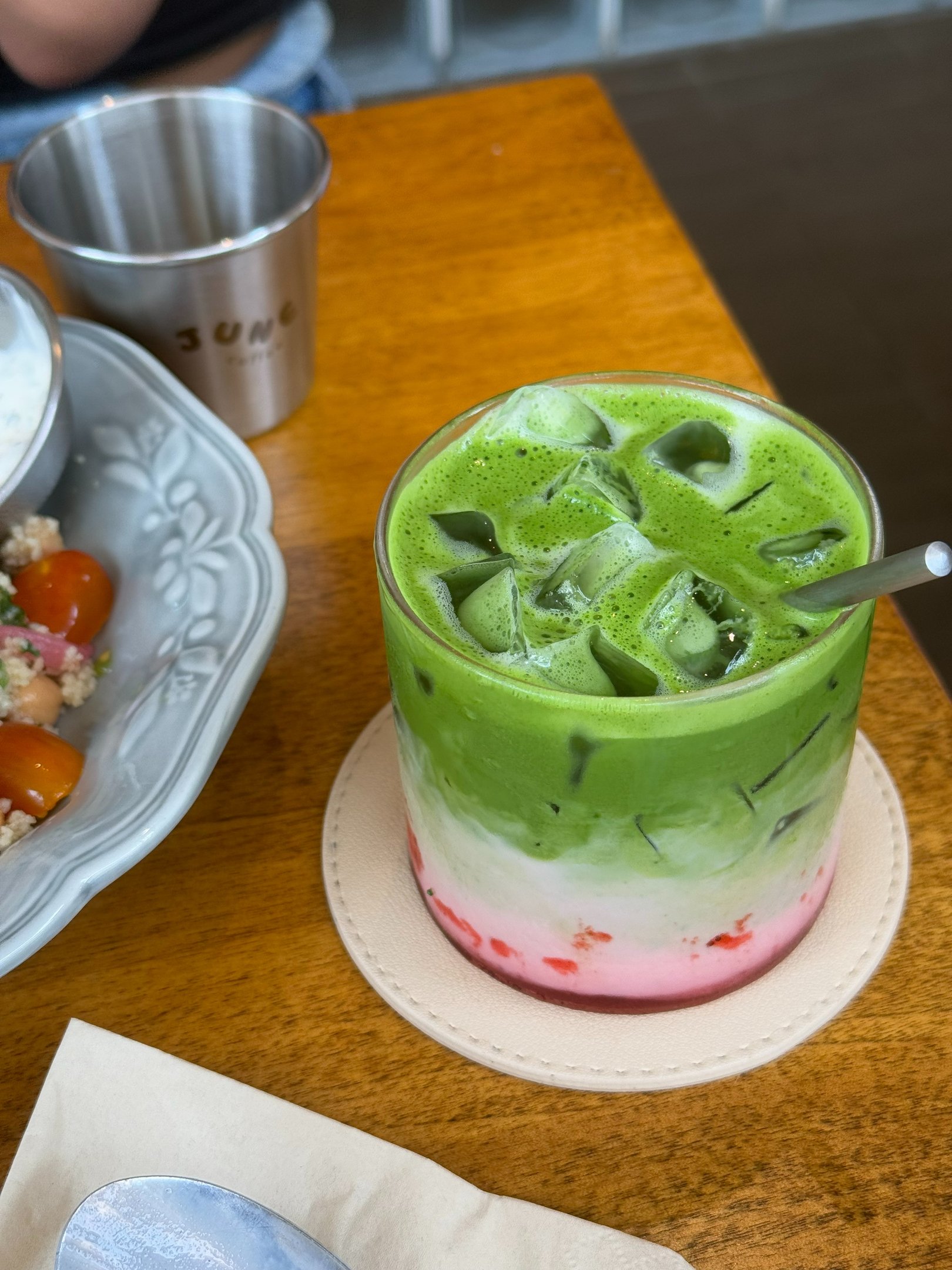 Layered strawberry matcha latte with fresh strawberries