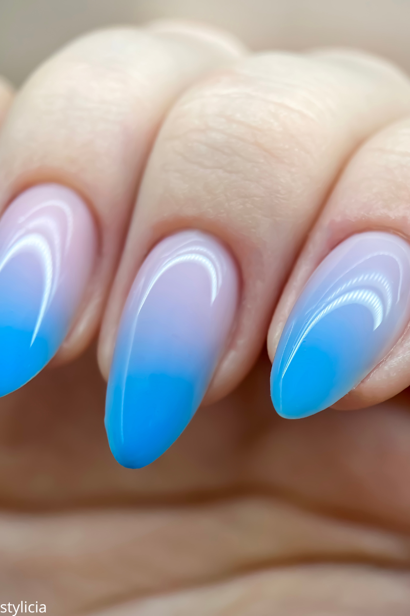 Blue ombre gel nails – elegant gradient nail design with soft pink and sky blue shades, perfect for wedding nail ideas or summer manicures.