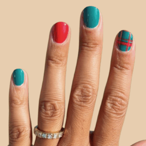 festive red and green Christmas nails 2025 with plaid accent design
