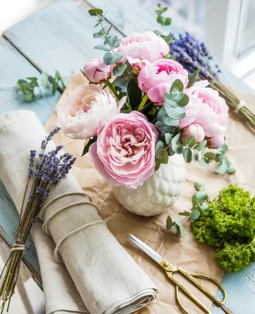 DIY spring home decor supplies flat lay with flowers and natural materials