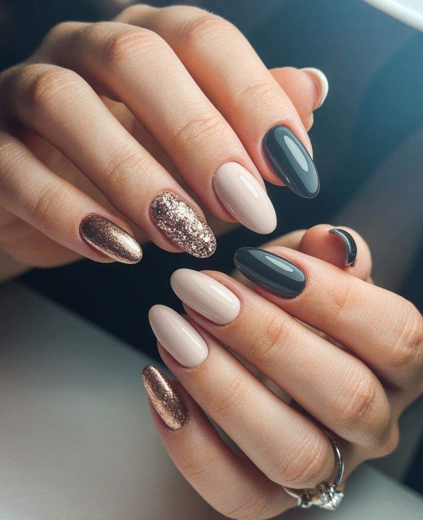 Elegant fall nails with nude polish, black accents, and bronze glitter – chic autumn manicure idea 2025