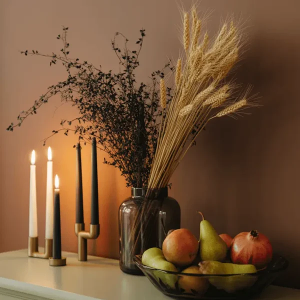 Elegant Halloween decor transitioning into Thanksgiving with dried wheat and ivory tapers