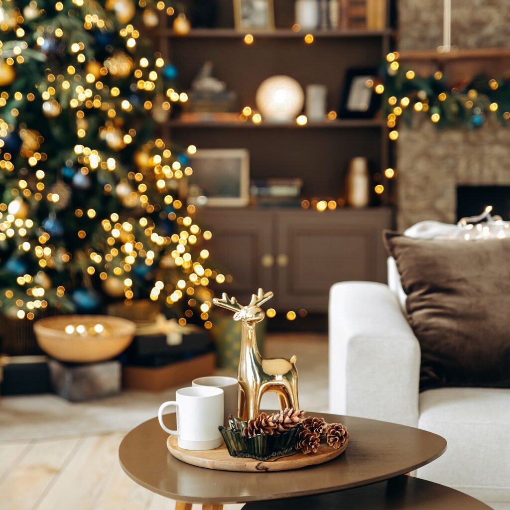Cozy and elegant Christmas coffee table decor with golden reindeer and pinecones in a festive living room.