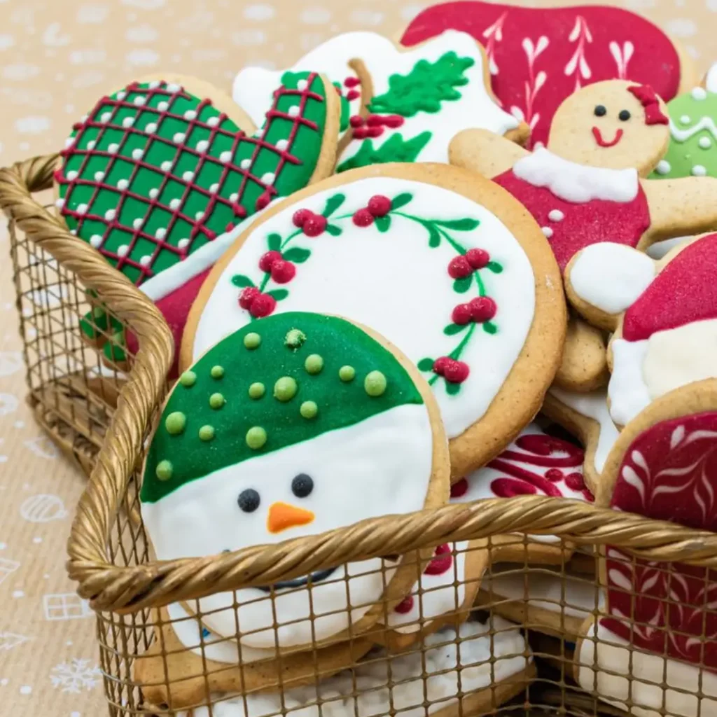 Decorated Christmas cookies in a basket, perfect as DIY edible Christmas gifts for coworkers.