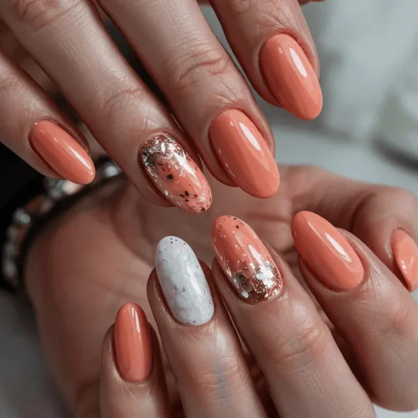 Short oval fall nails — peach coral solid with white marble effect accent nail and matching peach glitter accent