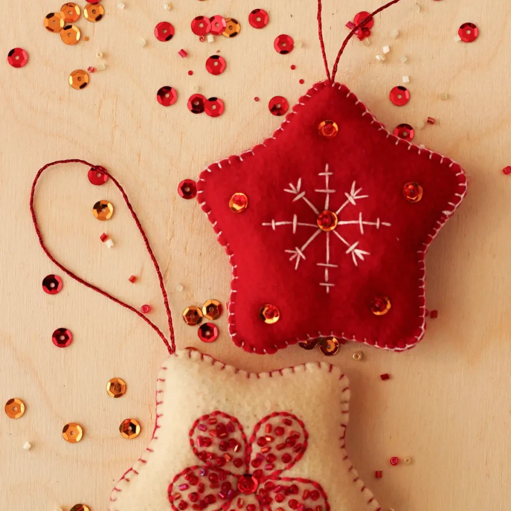 DIY Christmas room decor with handmade red felt star ornament decorated with sequins and embroidery
