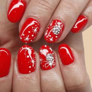 red Christmas nails 2025 with white snowflake and bow designs
