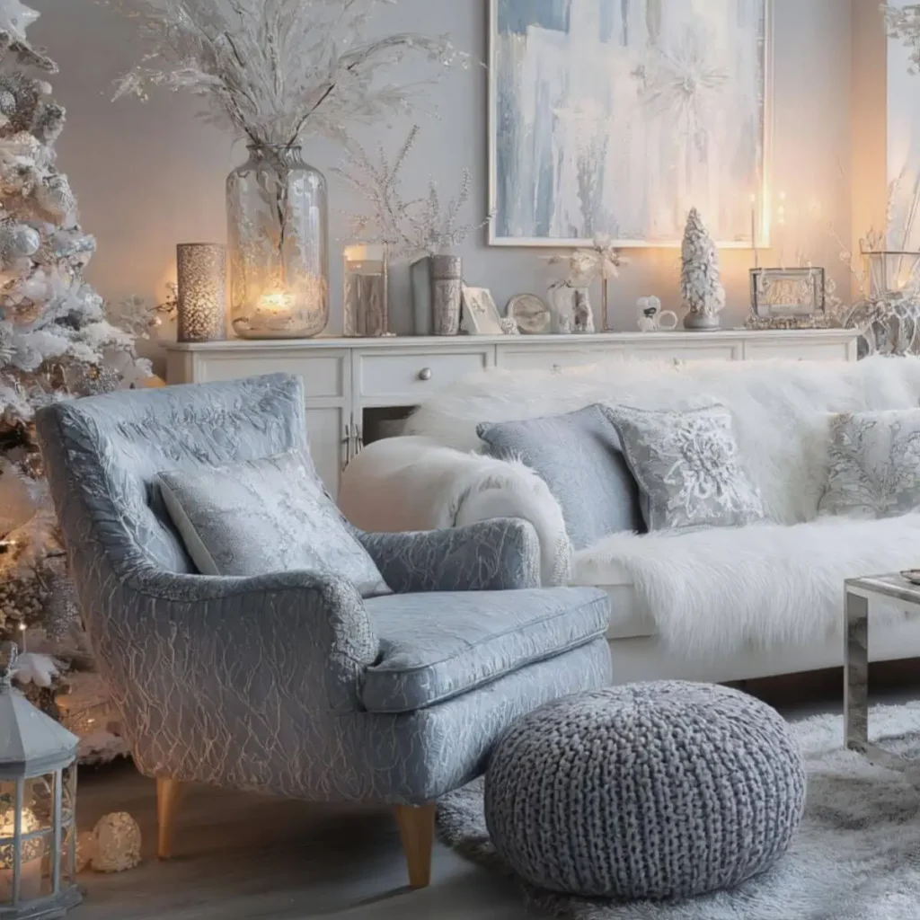 Cozy living room decorated with silver Christmas decor, including a fluffy white throw, soft blue pillows, a frosted Christmas tree, and warm candlelight for an elegant winter look.
