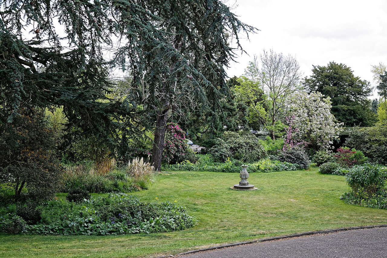 spring front garden ideas — beautiful English garden with lawn and flower borders in spring