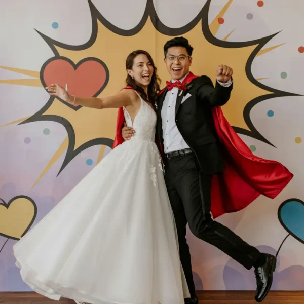 funny wedding photobooth pose – couple in superhero stance