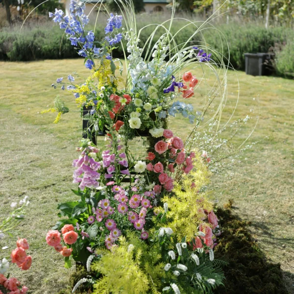 freestanding wildflower installation ceremony backdrop with tall vases